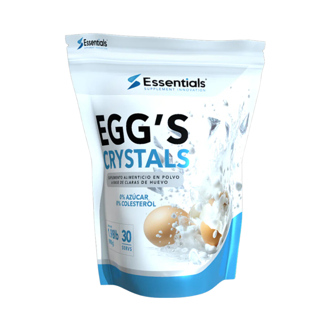 Una bolsa blanca y azul de Eggs Crystals Protein - ESSENTIALS de Get Fit México muestra un huevo roto y salpicaduras de leche, enfatizando proteínas de claras de huevo, con 0% azúcar, 0% colesterol, 13g de proteína, 30 porciones y es libre de lactosa.