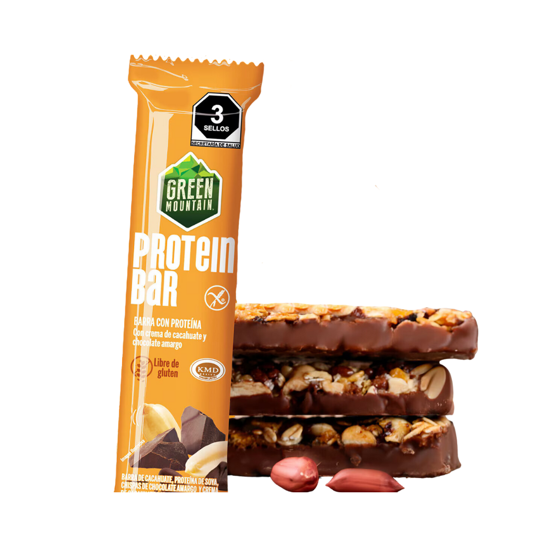 Una Barra de Proteína envuelta en naranja de Get Fit México se encuentra de pie junto a dos barras sin envolver con cobertura de chocolate, nueces visibles y relleno tipo caramelo. Hay tres cacahuates en la base. El texto destaca que no contiene gluten.